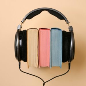 A pair of headphones rests on three books